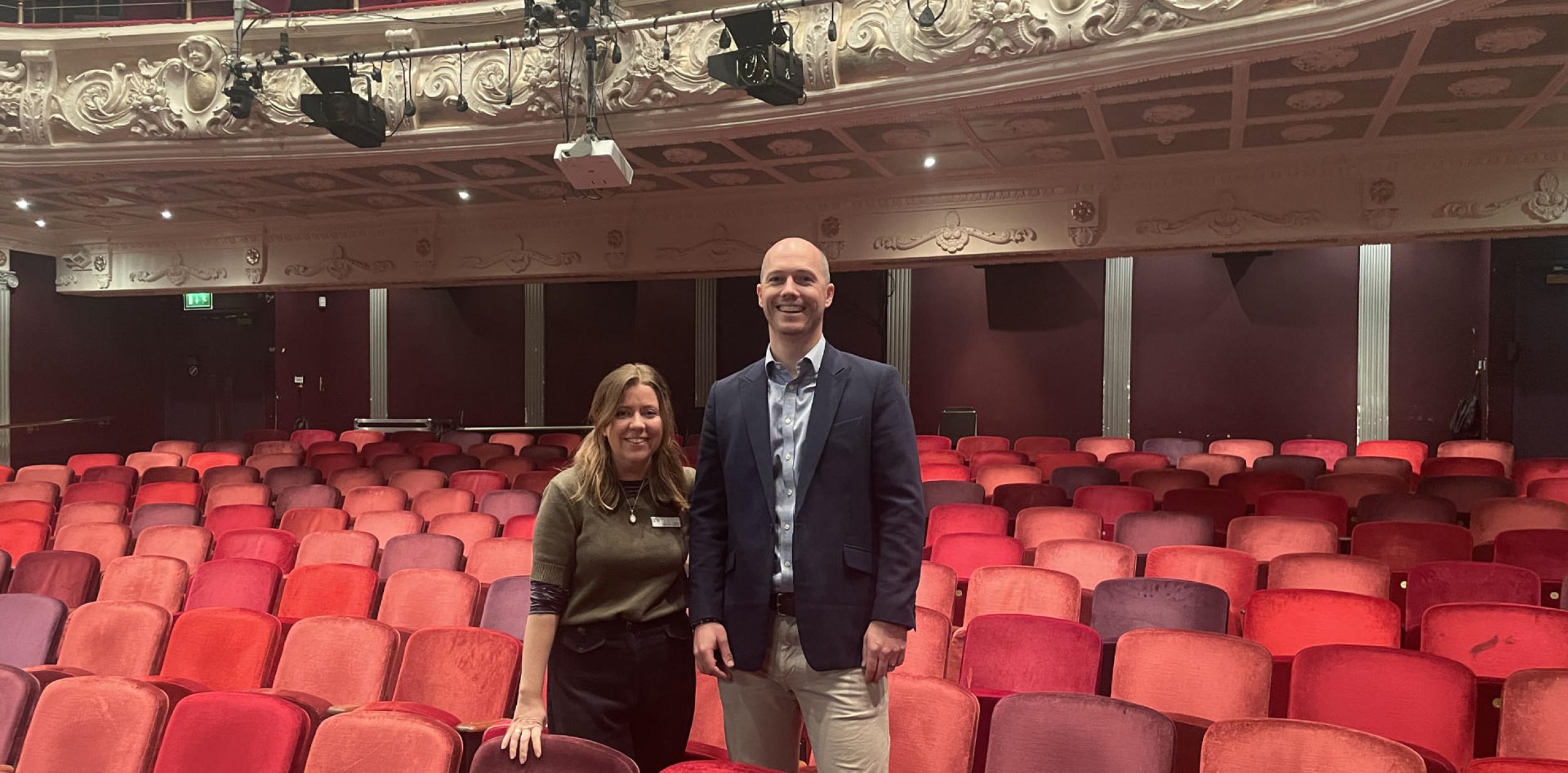 Becca Moore and Tom Collins stood in the Theatre Royal Winchester auditorium