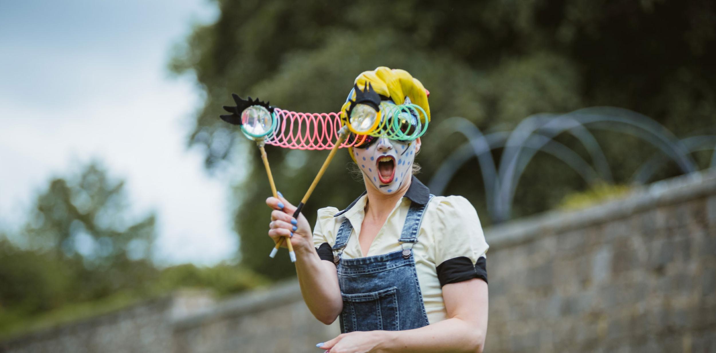 Performance at Hat Fair 2016 Out Door Arts festival. Lady with oversized googly eyed glasses and a surprised expression.