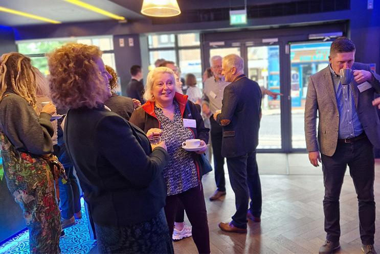 Business professionals enjoying coffee and tea in the theatre foyer