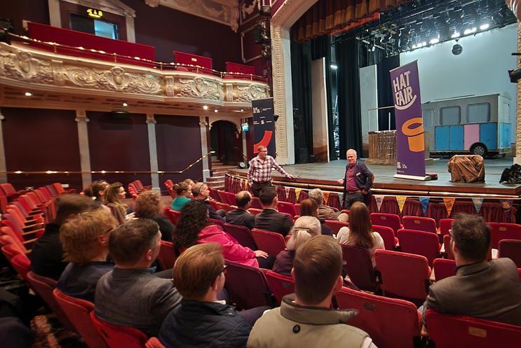 Business professionals listening to a talk in the theatre's auditorium
