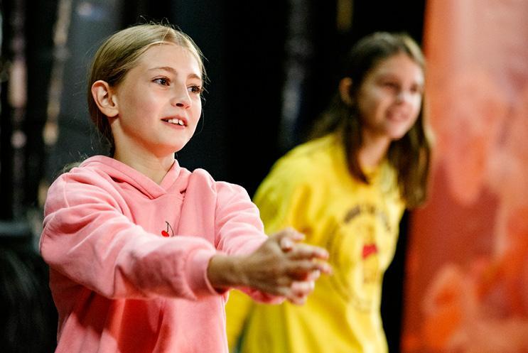 girls playing game on stage