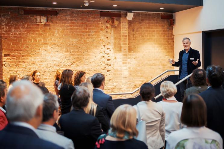 Deryck Newland giving a speech to a crowd of people
