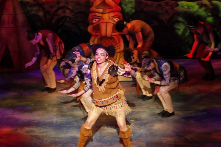 Panto character dancing on stage in native american costume