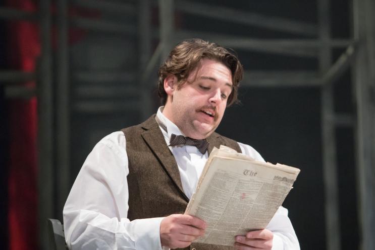 A man sat reading a paper