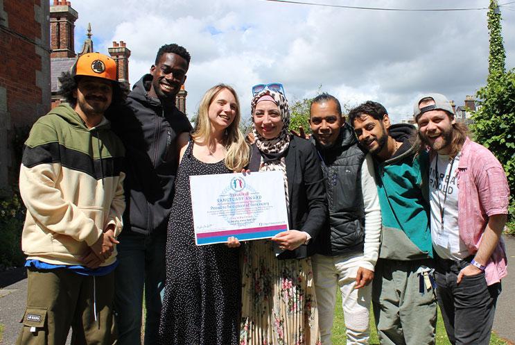 A group of people holding an award