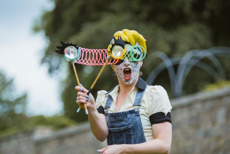 Performance at Hat Fair 2016 Out Door Arts festival. Lady with oversized googly eyed glasses and a surprised expression.